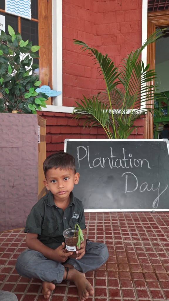Child holding a sapling during Plantation Day