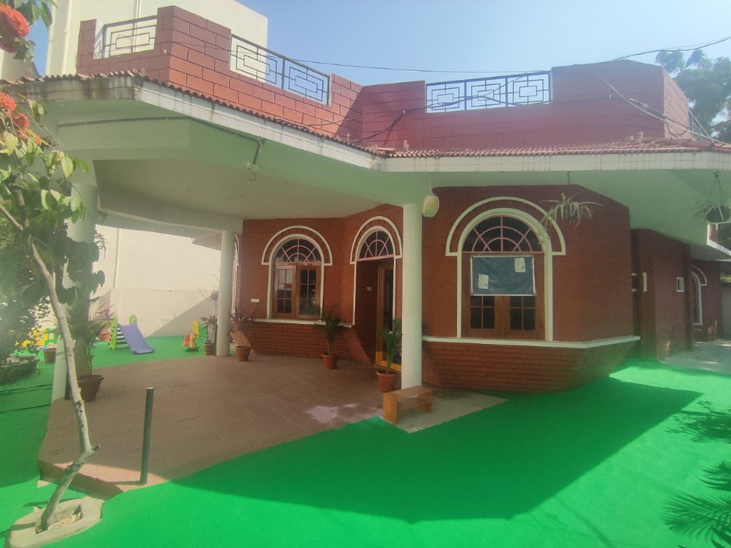 Preschool entrance with covered porch and play area