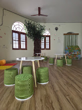 Classroom with round tables and green stools