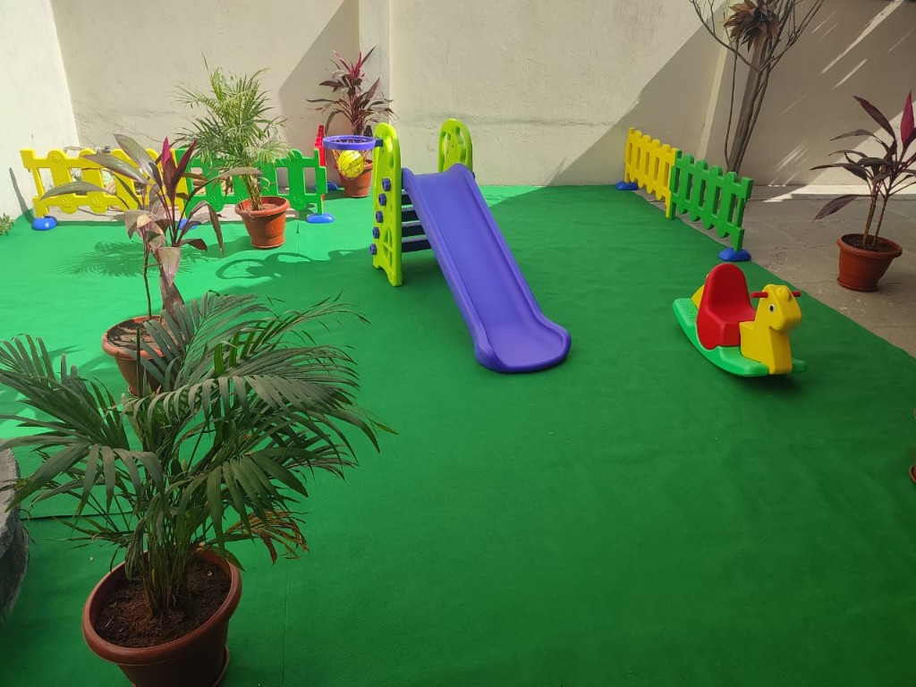 Outdoor playground with green turf and play equipment