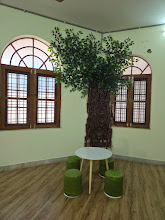 Reading corner with artificial tree and child-sized furniture